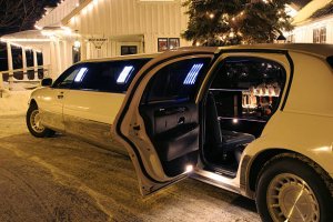 Your limo is waiting - Don't drink and drive - Bottles of bubbly visible inside the limo - Restaurant and Pub signs visible in the background.