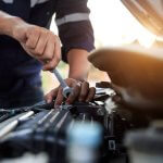 Automobile mechanic repairman hands repairing a car engine automotive workshop with a wrench, car service and maintenance,Repair service.