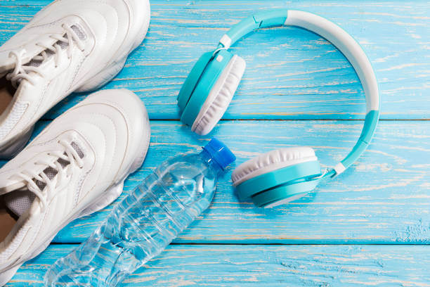 The concept of fitness with my running shoes and headphones. Top view with space for text.
