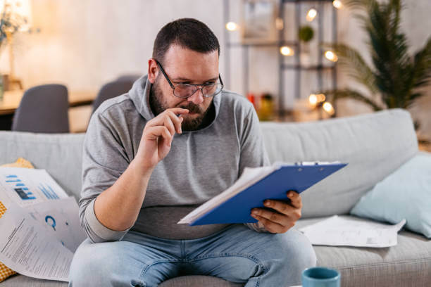 Young man checking his finances at home.