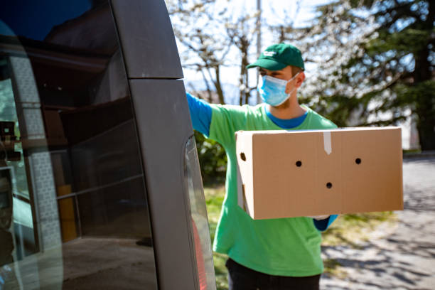 Young Adult Home Delivery Man Working During Coronavirus Pandemic.