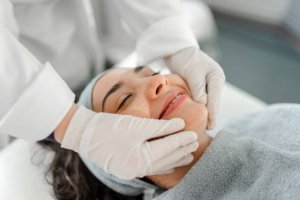 Happy woman receiving a beauty treatment