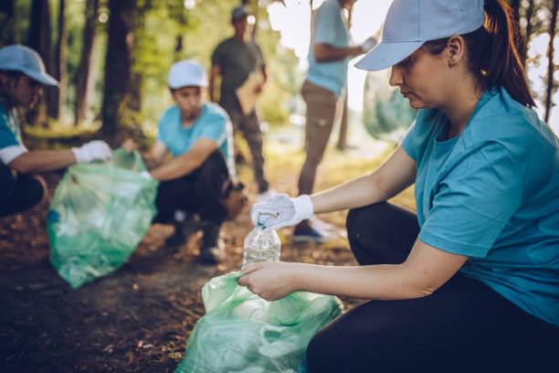 Group of people, cleaning together in public park, saving the environment.