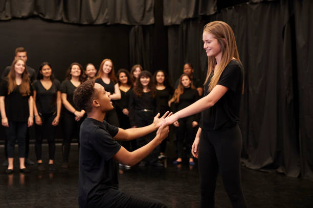 Male And Female Drama Students At Performing Arts School In Studio Improvisation Class