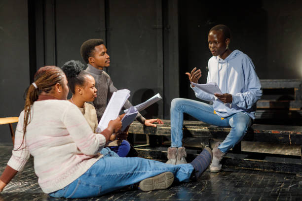 Group of black drama students doing an improv exercise in an acting class.