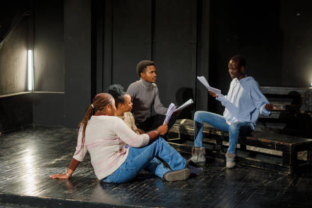 Group of black drama students doing an improv exercise in an acting class.