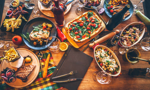 Different food cooked on a wooden table