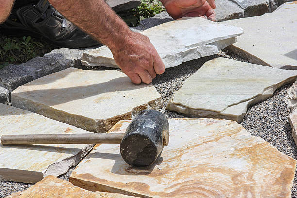 Worker ist paving a place in the garden.