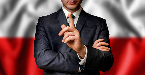 Polish candidate speaks to the people crowd with one finger on lips - election in Poland