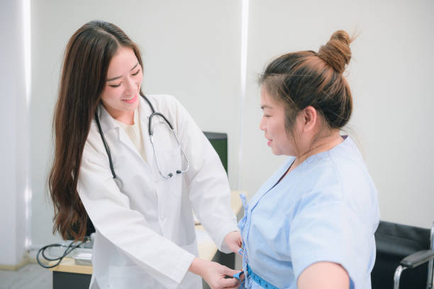 Young female doctor consulting overweight woman in clinic